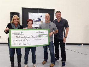 From left:  HCCF Board President Rhonda Wiles presenting grant check to Angela and Michael Nelson of Rock Steady Boxing, with HCCF Program Officer Eric Hessel. The grant was presented at the Rock Steady fundraiser "Boxing and Brunch" held at Don Schumacher Racing on November 5th. 